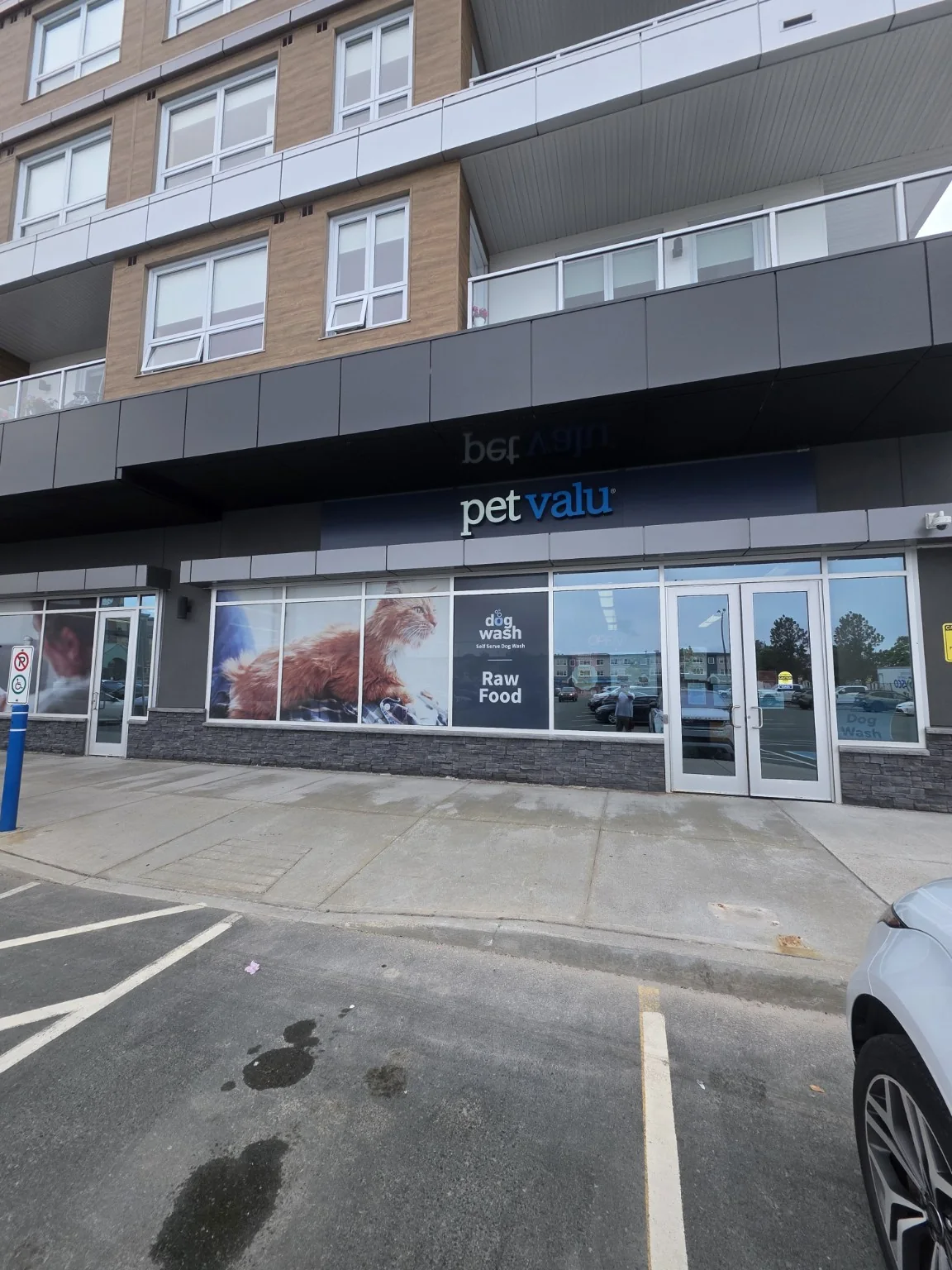 Pet Valu storefront below apartment building from rollout program