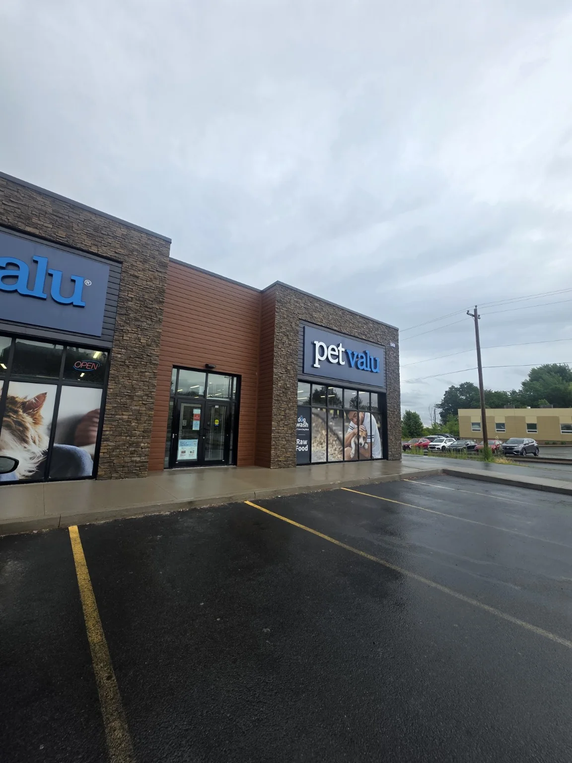 Pet Valu storefront completed during wet-weather rollout travel