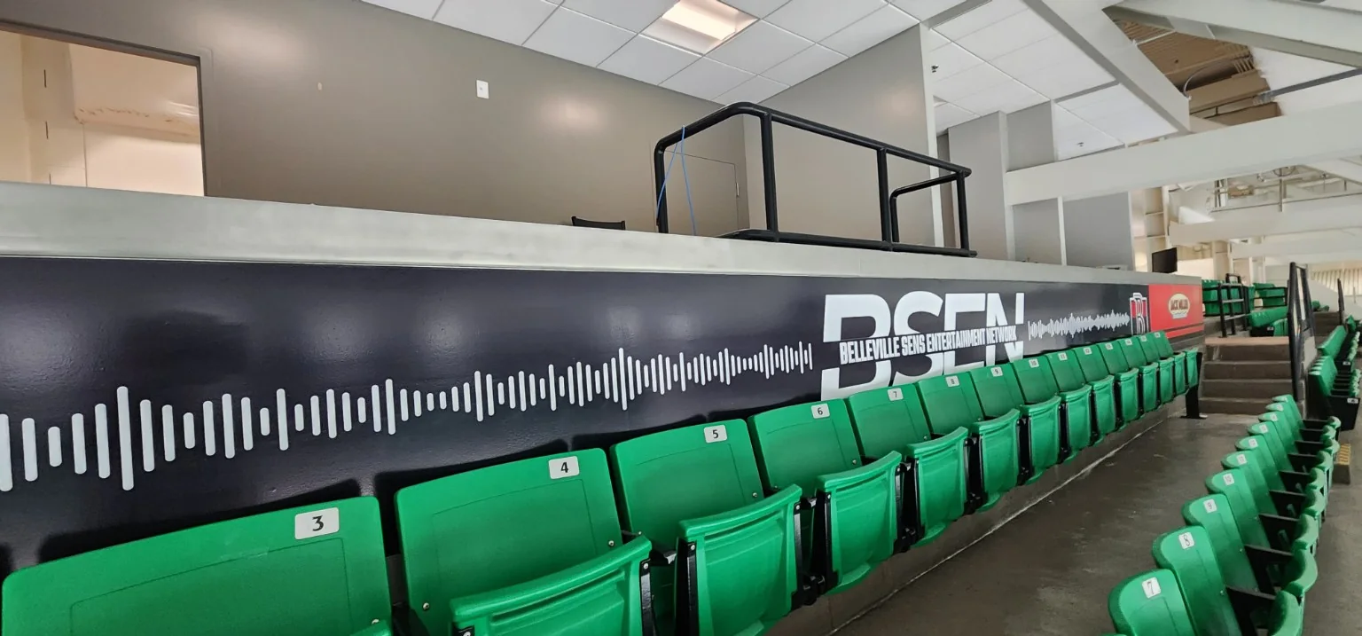 Belleville Senators BSEN arena seating wall graphics installed behind green spectator seats