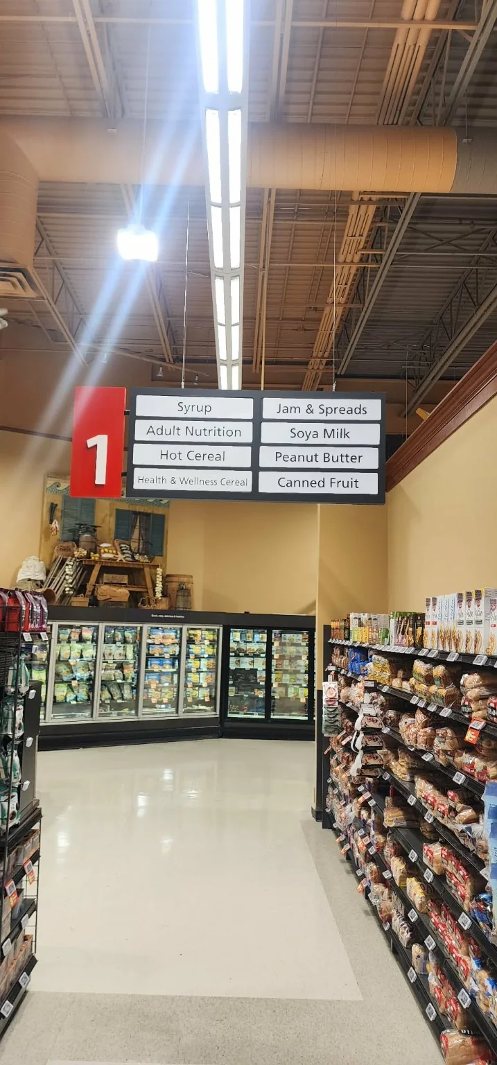Retail aisle identification and merchandising graphics