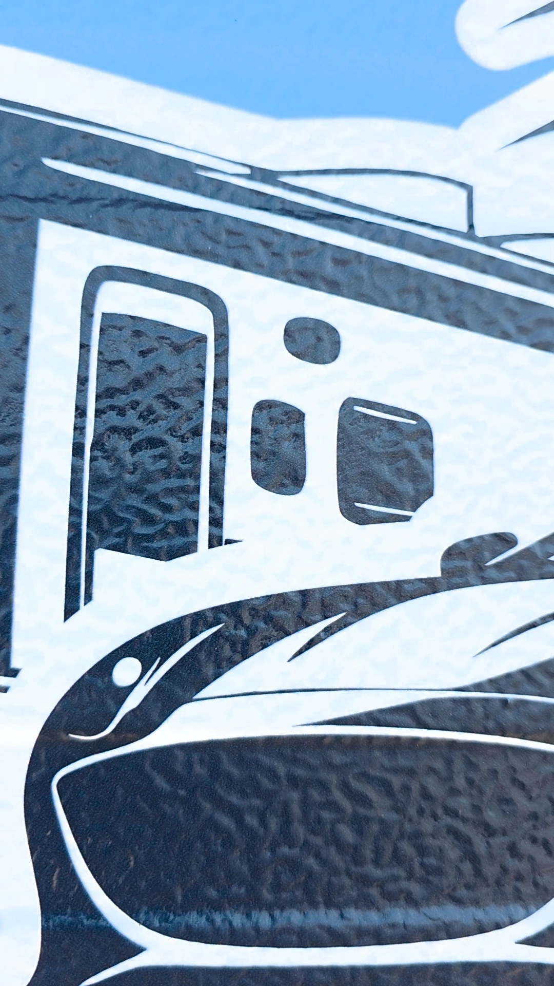 Close-up of graphic film conforming into a textured surface profile