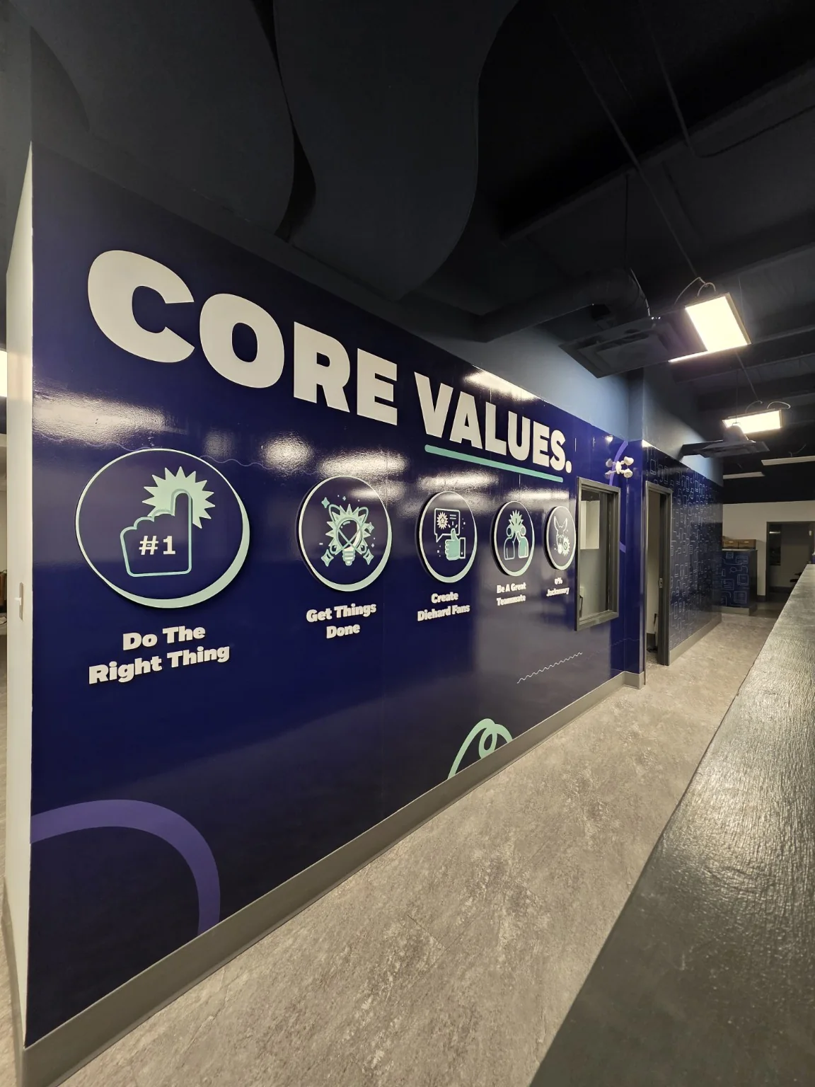 Finished branded interior with Core Values wall graphics and dimensional lettering