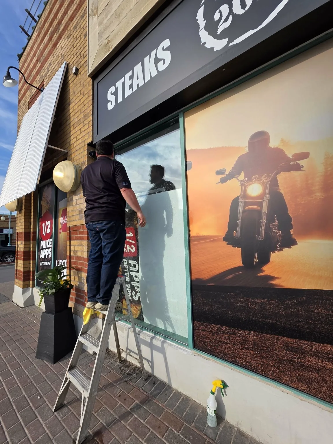 Wicked installer applying commercial storefront window graphics